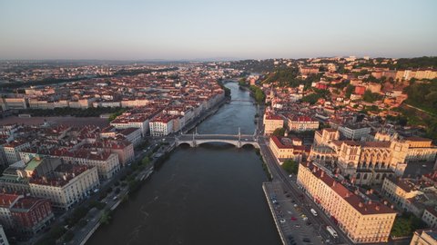 Establishing Aerial View Shot of Lyon Fr, Auvergne-Rhone-Alpes, France, sunset touches city
