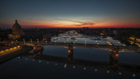 Establishing Aerial View Shot of Toulouse Fr, Haute-Garonne, France, at night evening, wonderful sunset sky