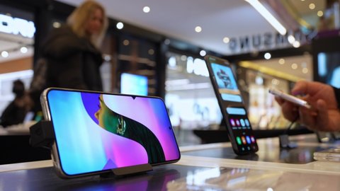 Samsung Galaxy Smartphones shown on display in electronic store. Customers choosing smartphones in mobile phone shop. Minsk, Belarus - april, 2022