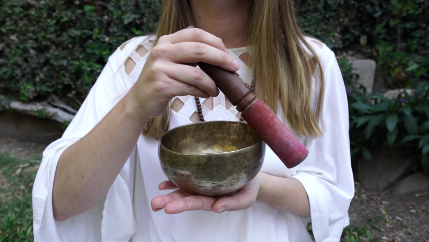 Woman Meditating with Singing Bowl 