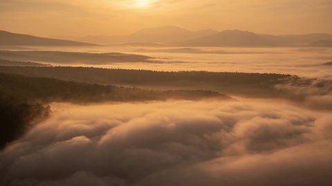 Stunning time lapse of drifting clouds during warm morning light on a sunrise over mountains. Nature of South Urals, Bashkortostan, Russia