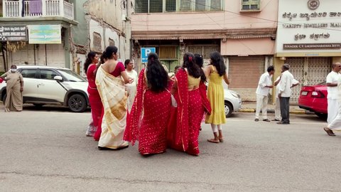 Mysuru,Karnataka,India-April 15 2022; Women wearing traditional Indian saris seen dancing  in the  street for the Mahavira Jayanti, a Jainism festival in Mysore, India.