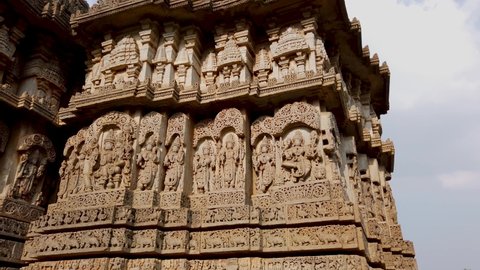 Hosaholalu, Karnataka, India-April 6 2022; Beautiful carvings of Deities in stone on the exterior walls of an Old Shiva temple named Lakshmi Narayana at Hosaholalu in Karnataka, India.