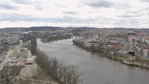 Vltava river in Prague urban area on bleak cloudy autumn day.