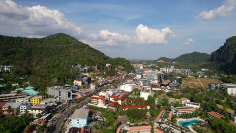 aerial drone of traffic and cars in Ao Nang Krabi Thailand surrounded by large mountains on a sunny summer day