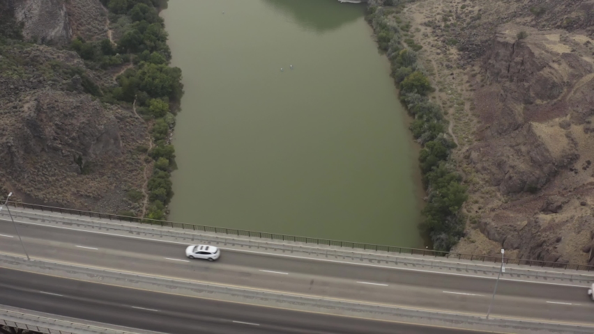 Birds Eye Aerial View of Highway Traffic on Perrine Truss Arch Span Bridge Above Deep Canyon of Snake River, Idaho USA Next to Shoshone Falls Park - Drone Tracking Back to Reveal Wate