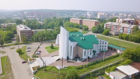 Russia, Irkutsk - July 27, 2018: Cathedral of the Immaculate Heart of the Mother of God. Catholic church, Protestant church. Architectural style - Constructivism, Aerial View Hyperlapse, Point of int