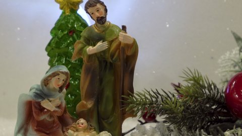 figurine of Joseph with Mary and Jesus with a Christmas star,twinkling stars over Christmas nativity scene with Christmas tree, beautiful Christmas background