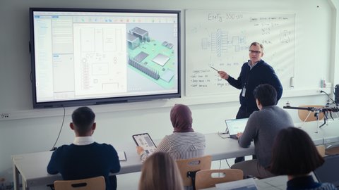 Male Teacher Explain to Students During Lesson About Computer Motherboard Components at University. He Uses projection screen . 3D Modelling of Circuit Board Concept. High Angle View