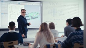Confident Male Teacher Using Digital Interactive Screen, Talk to Group of Diverse Students and Showing 3D Printed Circuit Board Concept. Education and High Tech Concept - Powered by Shutterstock - Get 15% off with code: PIKWIZARD15
