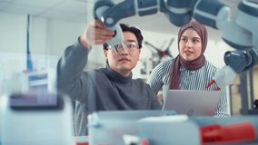 Muslim Female  Engineer Works with Asian Scientist, they Collaborate on Robot Arm Development Research and Manufacture Project. Analyzing and Evaluating Technology and Robotic System - Powered by Shutterstock - Get 15% off with code: PIKWIZARD15