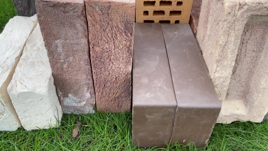 4k video review of different bricks lying on the grass