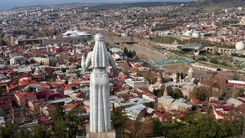 Statue of mother of Georgia in Tbilisi. Panoramic view of Tbilisi city. Statue of Mother Georgia - memorial is 50 meters high and watches over Georgia. Tbilisi, Georgia - april, 2022