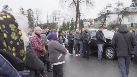 Ukraine, Lviv Oblast - April 2, 2022: Funeral of a soldier in a small village in Ukraine in the Lviv Oblast