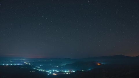 4K Time-Lapse Video motion of night sky with circular star trails over mountains foreground Pang Puai, Mae Moh, Lampang, Thailand.