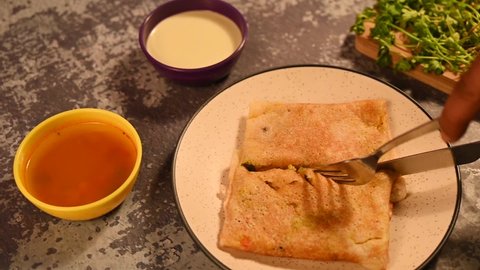 South Indian Dosha or popular Indian meal masala Dosa cutting video with chutney. prepare from rice powder.