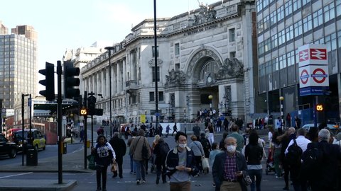 London, England, 04 20 2022. People crossing road to enter Waterloo train station in London.