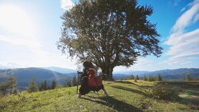 Woman in black dress playing violoncello sitting on the high hill. Musician performing classical music in the strong wind at the backdrop of mountains. - Powered by Shutterstock - Get 15% off with code: PIKWIZARD15