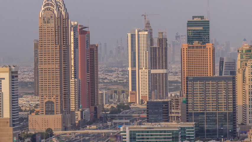 Aerial view of Sheikh Zayed Road in Dubai Internet City and barsha area timelapse. Skyscrapers and traffic on a highway with downtown on a background during sunset