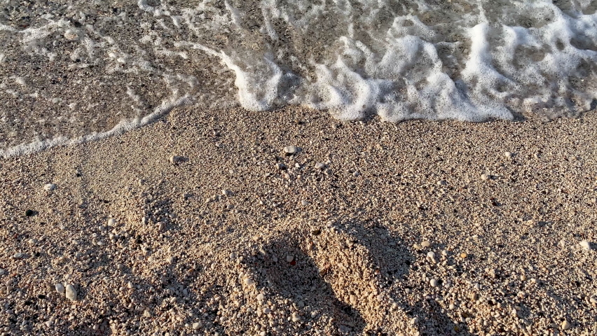 Close up sea wave. Water sea wave sandy. Yellow sand and clear water sea ocean beach in the morning