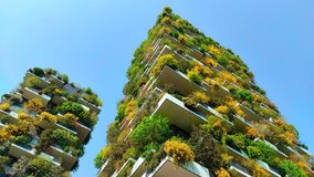 Low angle view of Bosco Verticale (Vertical Forest) in district of Porta Nuova, Milan, Italy. 4k video time lapse.