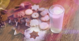 Animation of light spots over milk and cookies at christmas. world milk day and christmas concept digitally generated video.