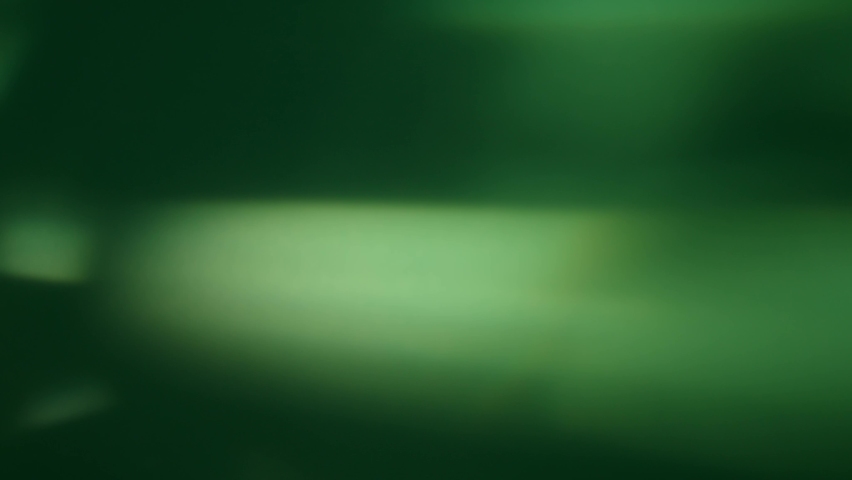 Abstract lights and shadows rotation in green background in the room, beautiful motion colors and rays. 8K downscale, 4K. Royalty-Free Stock Footage #1089492405