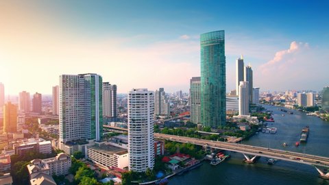 BANGKOK THAILAND - 2022 March 26, Aerial view over Bangkok city and Chao phraya river. Lots of high rise buildings in the economic district in Bangkok, Thailand. Drone 4K shot.

