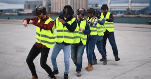 Multiracial workers using virtual reality headsets at industrial terminal Port