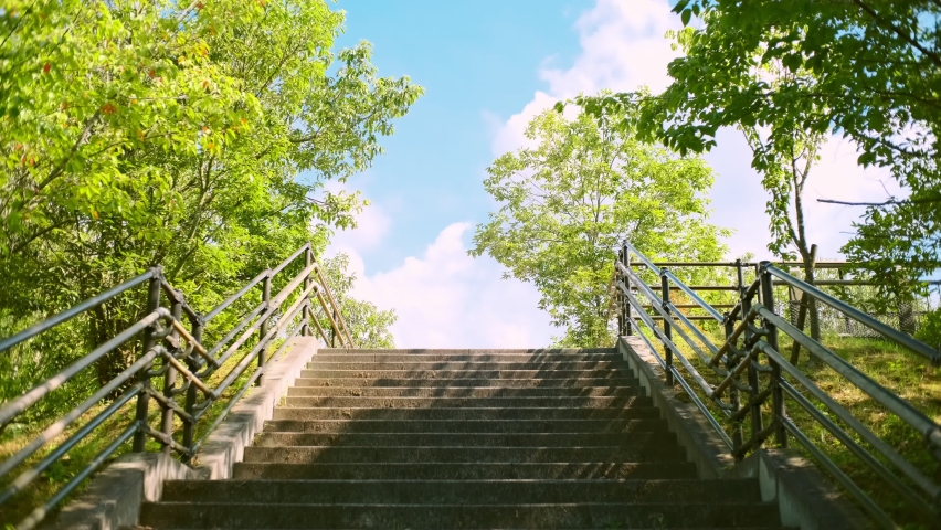 Dramatic landscape of blowing leaves by stairs or steps and flowing clouds in the blue sky, Fresh park under the blue sky in summer, Nobody