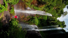 Active lifestyle travel people enjoy beautiful waterfall hidden in tropical rainforest jungle on nature background 4K Vertical video - Powered by Shutterstock - Get 15% off with code: PIKWIZARD15
