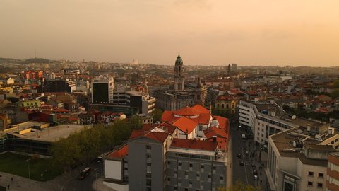 Sunset Over The City Of Porto In Portugal With Scenic View Of Catholic Church Building And City Hall. drone ascend