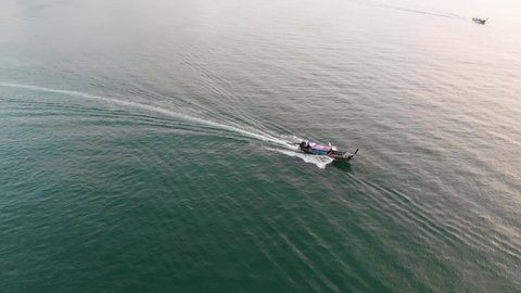 Aerial Drone Shot Tracking A Long Tail Boat At Ao Nang Beach, Whilst The Sun Sets In The Background. Krabi, Thailand