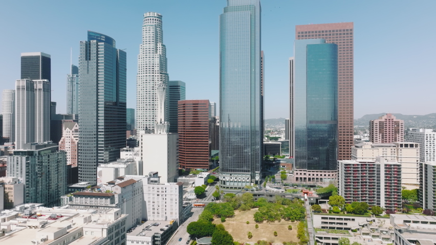 Cinematic aerial downtown Los Angeles on sunny summer day, California, West coast, USA. American city with financial district, banks and hotels in modern skyscraper buildings from glass and concrete