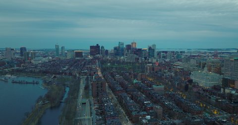 Aerial panoramic descending footage of Back Bay borough at dusk. Cityscape view downtown skyscrapers in distance. Boston, USA
