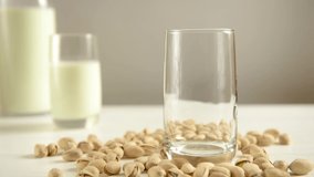 Pour pistachio milk into a glass. HD video