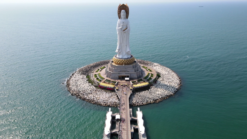 Aerial fly over drone footage of Guanyin of the South Sea statue of Nanshan Buddhism cultural park temple in Sanya Hainan island China