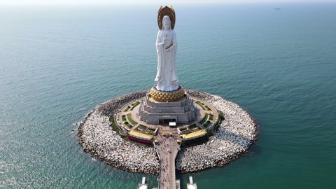 Aerial fly over drone footage of Guanyin of the South Sea statue of Nanshan Buddhism cultural park temple in Sanya Hainan island China