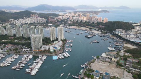 Aerial fly over drone cityscape footage of Sanya city with marina and buildings on Hainan tropical island China
