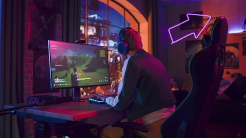 Professional eSports Female Gamer Plays 3D Shooter Video Game with Lots of Action and Fun on Her Powerful Personal Computer at Home. Cyber Gaming Stylish Retro Neon Room.