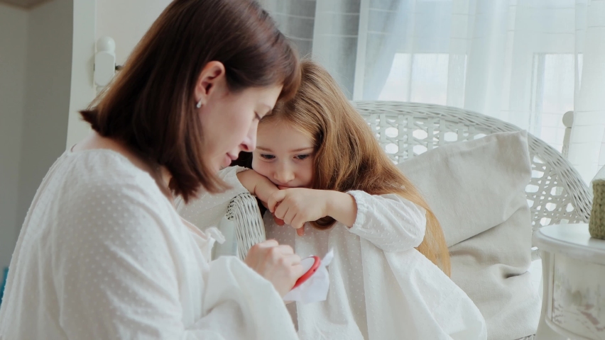 Portrait of young mother is teaching her cute little daughter to embroidery with embroider frame at home, 4k | Shutterstock HD Video #1089515479