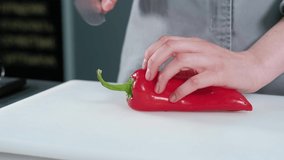 Close up video of chef cutting red pepper in kitchen