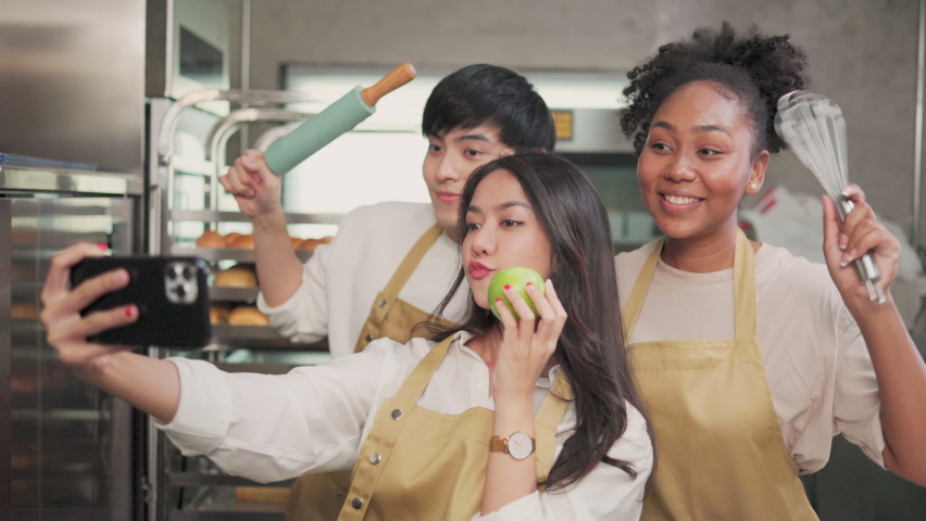 Students In Cookery Class Mixing Ingredients For Recipe In Kitchen.Group of young people taking selfie during cooking classes. Royalty-Free Stock Footage #1089517841
