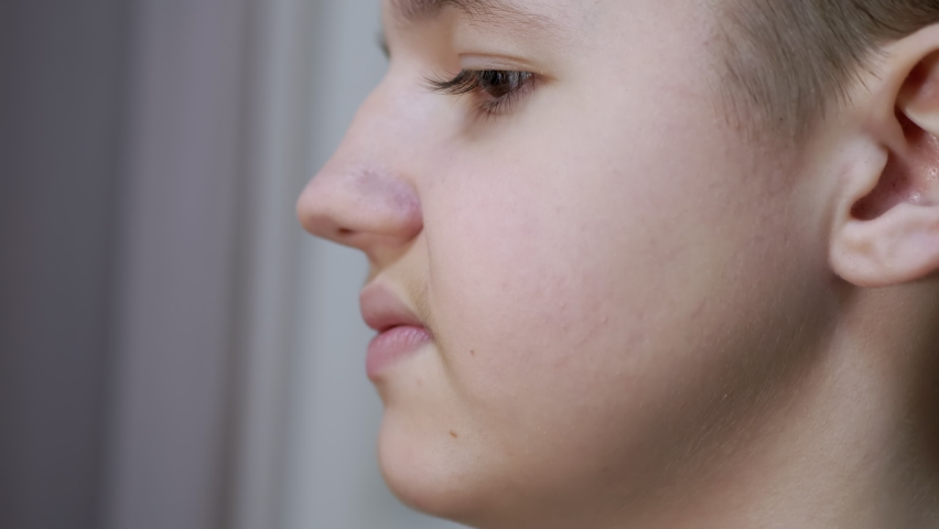 Face Profile of a Talking Displeased Teenager Moving his Lips. Close-up. Head of a child with long eyelashes, mustache. Part of the face. Conversation, behavior, emotions, mouth gestures. Side view. | Shutterstock HD Video #1089519545