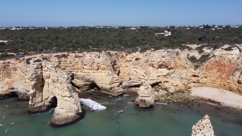 Drone flying away from the cliffs, Marinha Beach, Algarve, Portugal