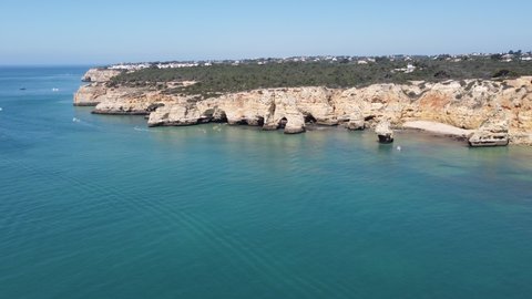 Drone flying towards the cliffs, Marinha Beach, Algarve, Portugal