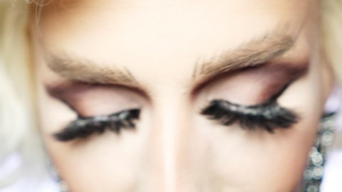 defocus. close-up of the eyes of a travesty actor with eye-catching makeup, focus on the eyes.