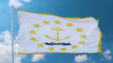 Rhode Island flag on a flagpole waving in the wind, blue sky background
