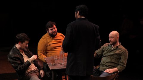 Kirkland , WA , United States - 01 13 2022: four men drinking in a dark bar room. 