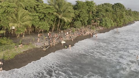 Punta Uvita , Costa Rica - 03 26 2016: People bathing and surfing at Uvita beach in the Pacific coastline during the Envision Festival gathering